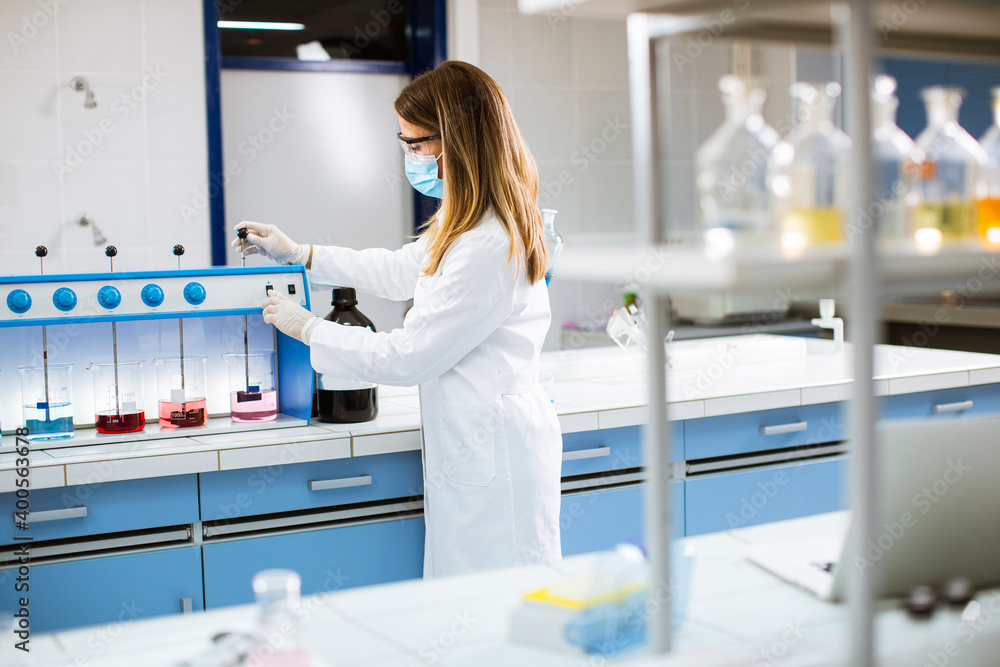 Young researcher analyzing chemical data in the flocculator at laboratory Young researcher analyzing chemical data in the flocculator at laboratory