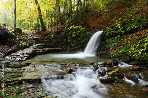 Waterfall in the autumn beech forest.