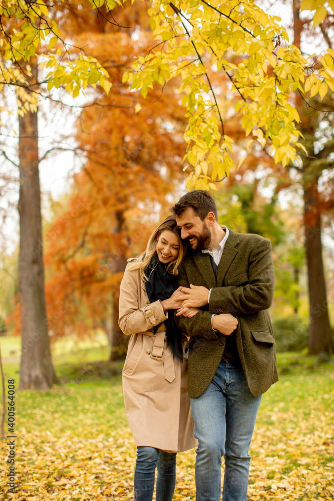 Young couple walking in the autumn park