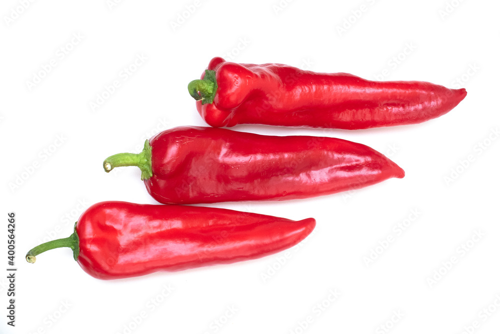 Group of red beautiful peppers of different sizes on a white background