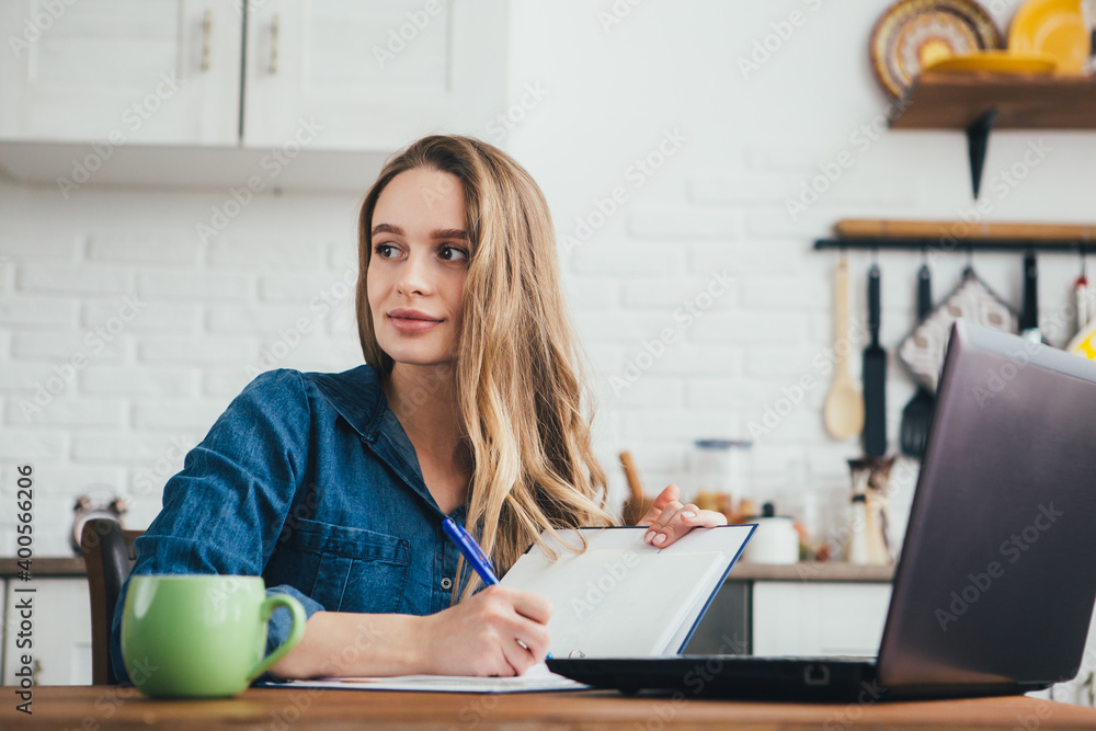 Pregnant girl a freelancer working at home in the kitchen Pregnant girl a freelancer working at home in the kitchen