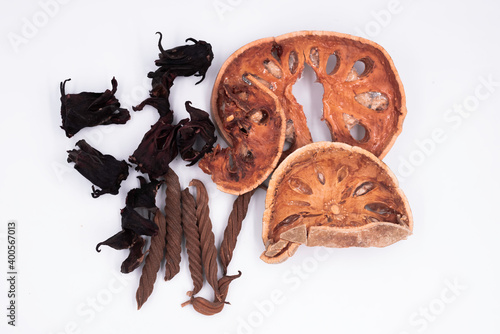 Sliced bael fruit,dried roselle and east indian sxrew tree put on background photo