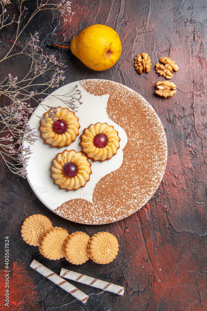 top view yummy little cookies inside plate on the dark background cake sweet biscuits sugar top view yummy little cookies inside plate on the dark background cake sweet biscuits sugar