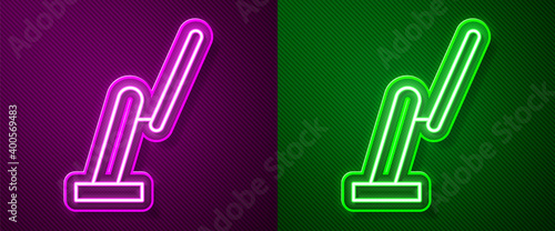 Glowing neon line Windscreen wiper icon isolated on purple and green background. Vector Illustration.