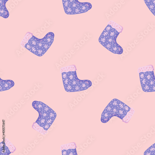 Random seamless pattern with hand drawn wool blue winter shoes ornament. Pink background.