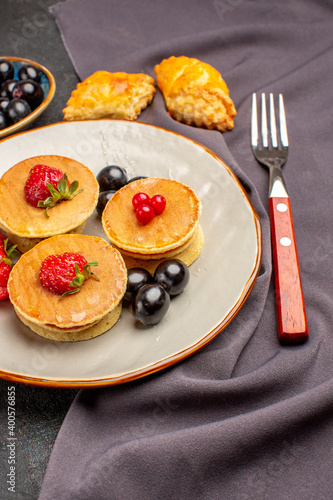 front view yummy pancakes with fruits and olives on a dark background sweet fruit cake