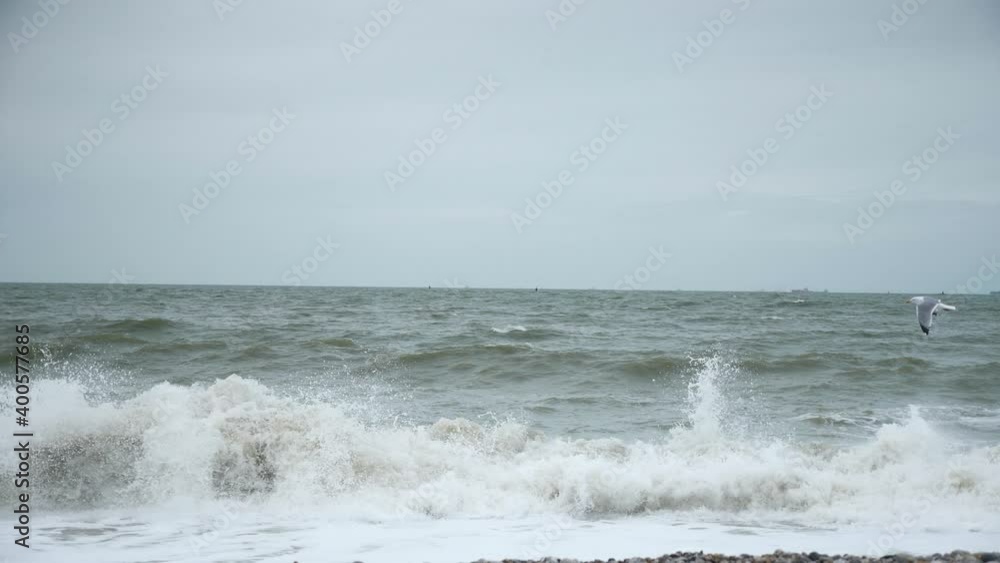 Stormy Sea. Stony Seashore. Waves Crashing on Pebble Beach. Atlantic Ocean. Grey Overcast Sky. English Channel. Le Havre Normandy France Europe. 2x Slow motion 60 fps 4K Stormy Sea. Stony Seashore. Waves Crashing on Pebble Beach. Atlantic Ocean. Grey Overcast Sky. English Channel. Le Havre Normandy France Europe. 2x Slow motion 60 fps 4K