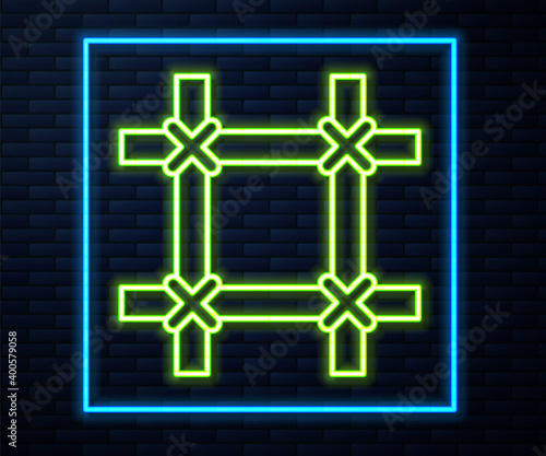 Glowing neon line Prison window icon isolated on brick wall background. Vector.