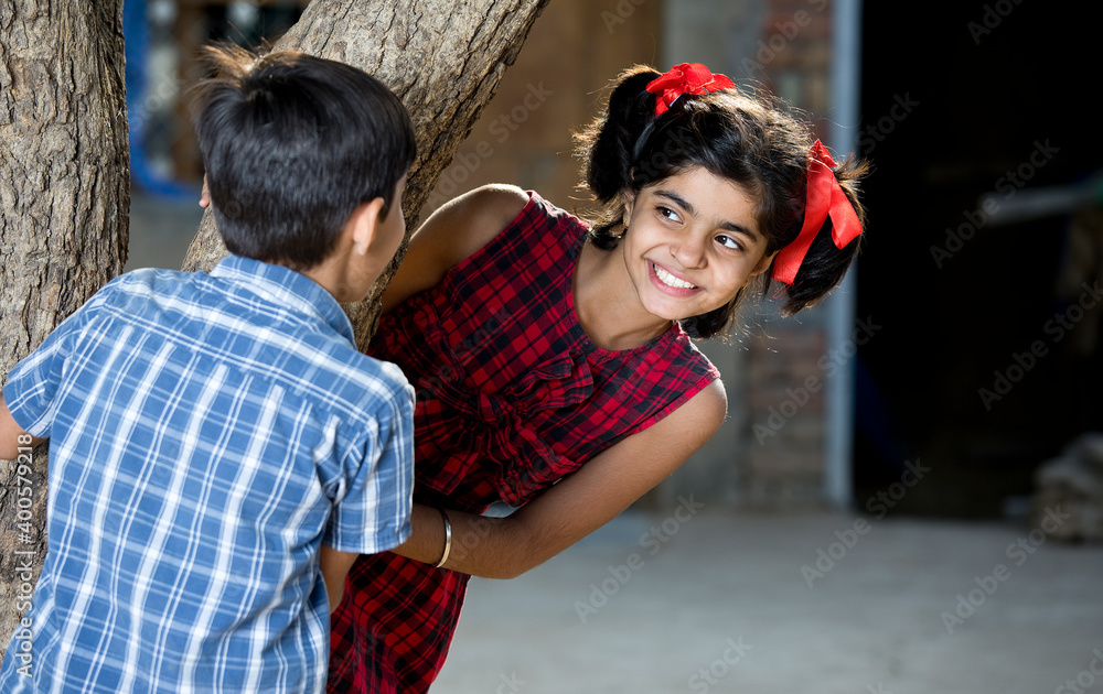 boy with girl playing hide and seek boy with girl playing hide and seek