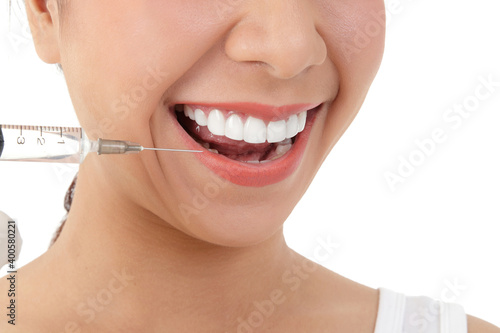 The doctor hand held the syringe to inject the girl's face to treat acne. Skin care beauty concept . White background