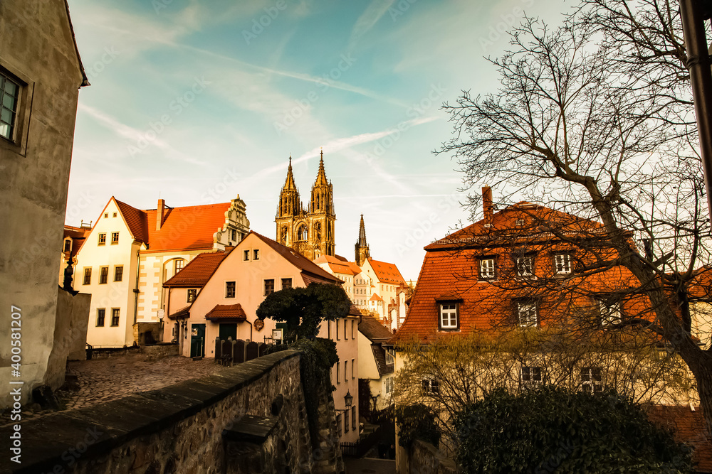 Naklejka premium Meissen,Saxony, Germany. 17.02. 2019, .pedestrian old German street at sunset. cobblestone pavement, .ancient gothic church