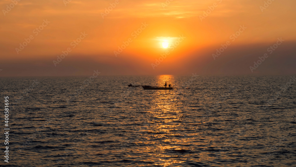 Silhouette fisherman on fishing boat at sunset, Bang Pu