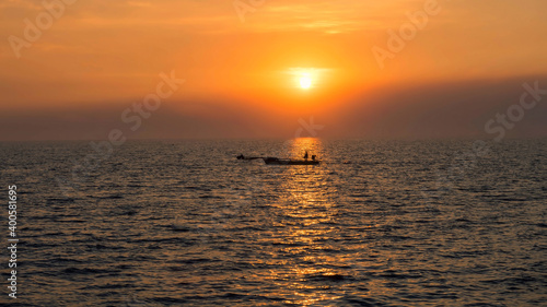 Silhouette fisherman on fishing boat at sunset, Bang Pu © Blanscape