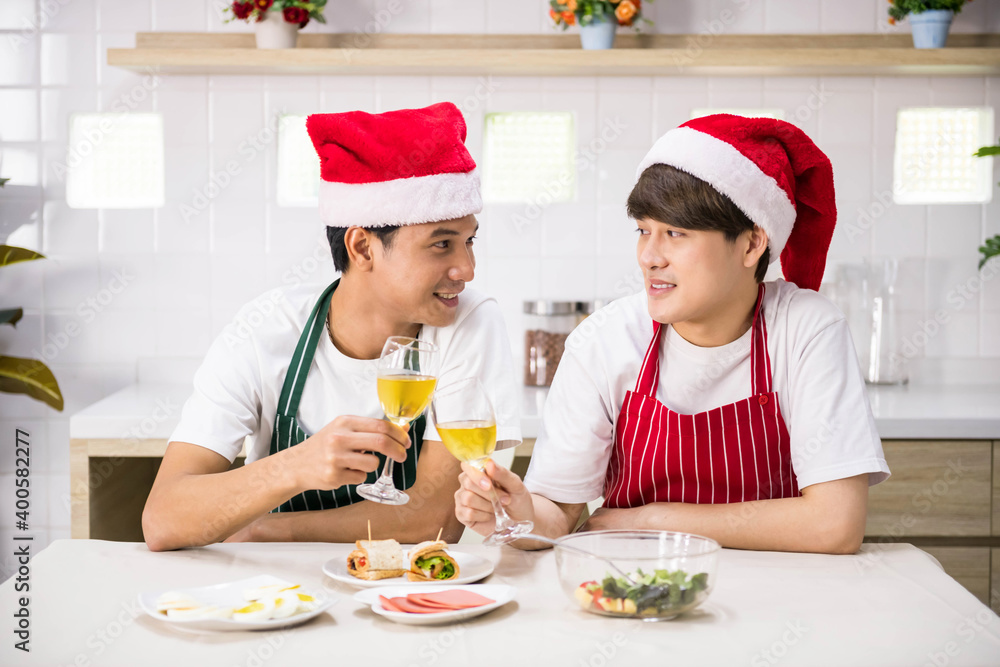 Gay couple toast wine to celebrate Christmas at lunch Gay couple toast wine to celebrate Christmas at lunch