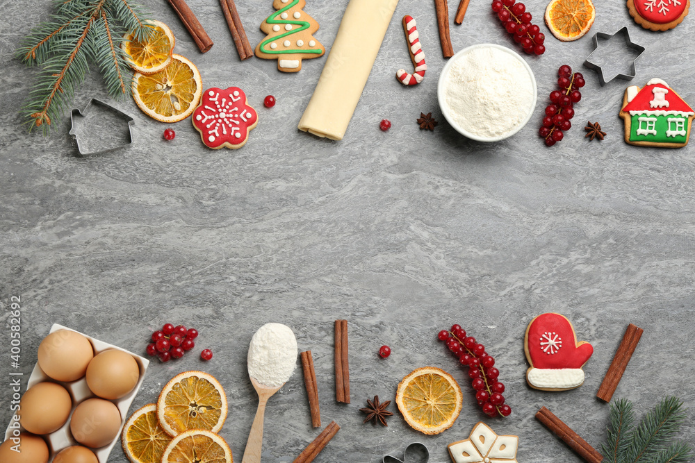 Frame of Christmas cookies and flour on grey table, flat lay. Space for text Frame of Christmas cookies and flour on grey table, flat lay. Space for text