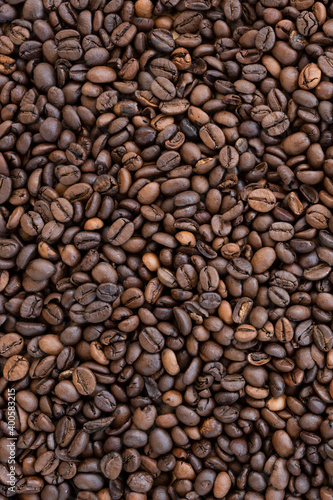 Flat lay with copy space  close-up view of some roasted coffee beans forming a natural pattern. Natural background.