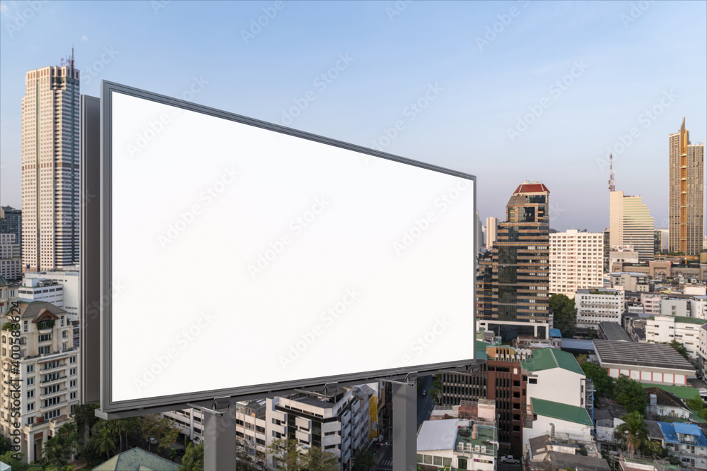 Blank white road billboard with Bangkok cityscape background at day time. Street advertising poster, mock up, 3D rendering. Side view. The concept of marketing communication to promote or sell idea. Blank white road billboard with Bangkok cityscape background at day time. Street advertising poster, mock up, 3D rendering. Side view. The concept of marketing communication to promote or sell idea.