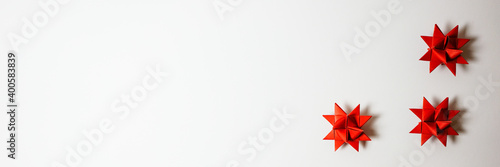 panorama christmas origami star, froebel star in red with dark background with copyspace