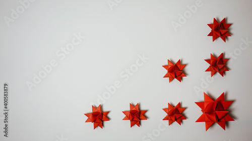 panorama christmas origami star, froebel star in red with dark background with copyspace