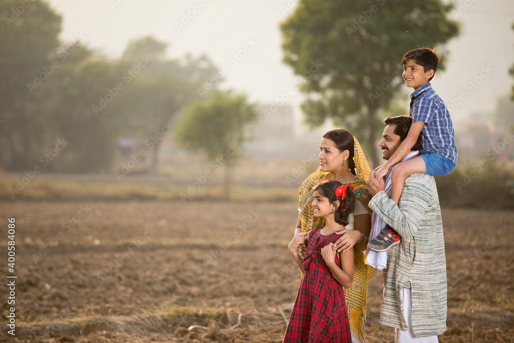 Happy rural Indian family on agricultural field Happy rural Indian family on agricultural field