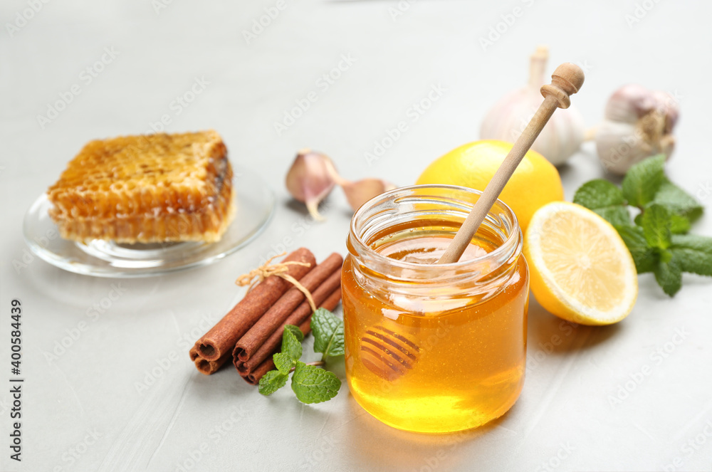 Honey, cinnamon and other fresh products on grey table. Natural antibiotics Honey, cinnamon and other fresh products on grey table. Natural antibiotics