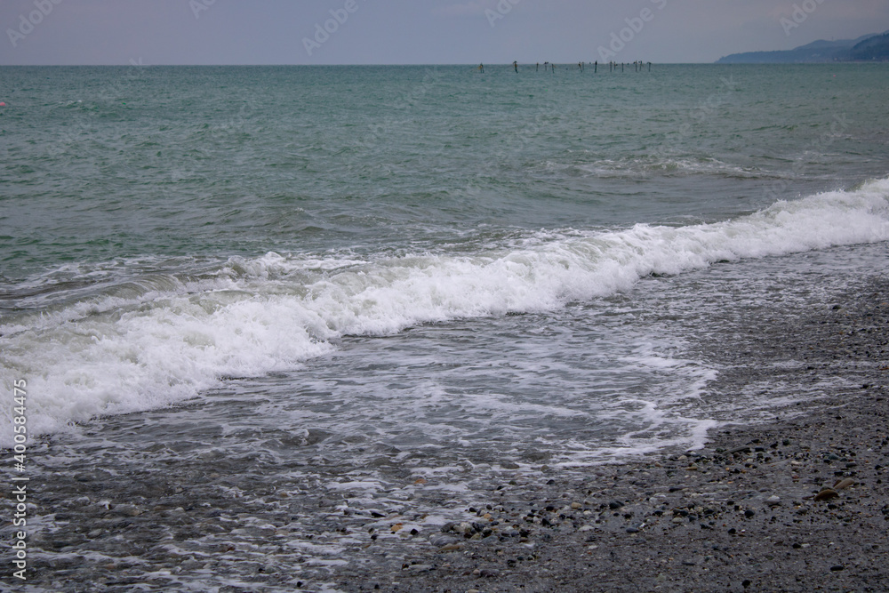 The Black Sea coast of Sochi on a warm, cloudy summer day. The Black Sea coast of Sochi on a warm, cloudy summer day.