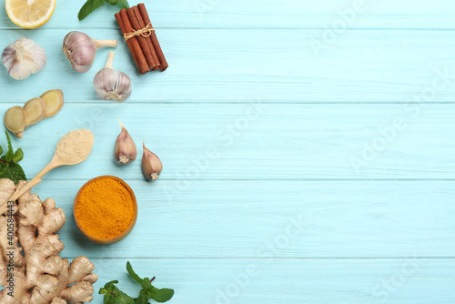 Flat lay composition with fresh products on light blue wooden background, space for text. Natural antibiotics