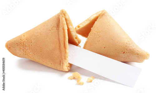Cracked traditional fortune cookie with prediction on white background
