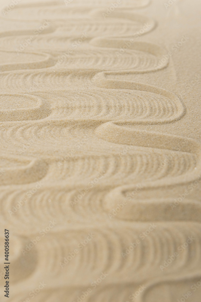 Obraz premium Zen sand garden meditation stone background with copy space. Stones and lines drawing in sand for relaxation. Concept of harmony, balance and meditation, spa, massage, relax. Set Sail Champagne color