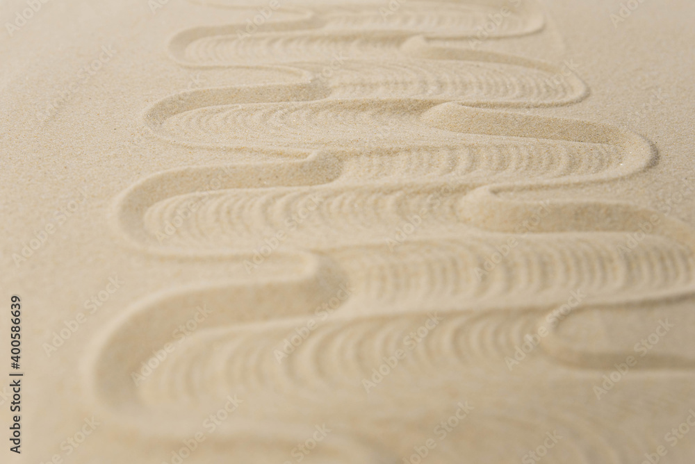 Obraz premium Zen sand garden meditation stone background with copy space. Stones and lines drawing in sand for relaxation. Concept of harmony, balance and meditation, spa, massage, relax. Set Sail Champagne color