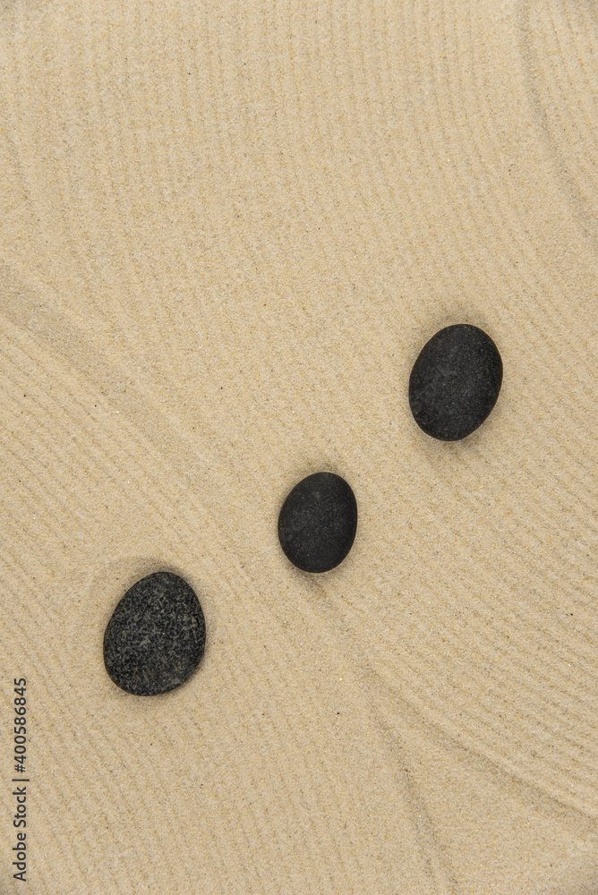 Zen sand garden meditation stone background with copy space. Stones and lines drawing in sand for relaxation. Concept of harmony, balance and meditation, spa, massage, relax. Set Sail Champagne color Zen sand garden meditation stone background with copy space. Stones and lines drawing in sand for relaxation. Concept of harmony, balance and meditation, spa, massage, relax. Set Sail Champagne color