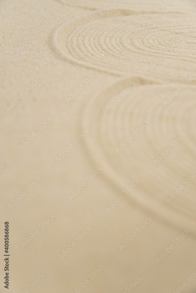 Obraz premium Zen sand garden meditation stone background with copy space. Stones and lines drawing in sand for relaxation. Concept of harmony, balance and meditation, spa, massage, relax. Set Sail Champagne color