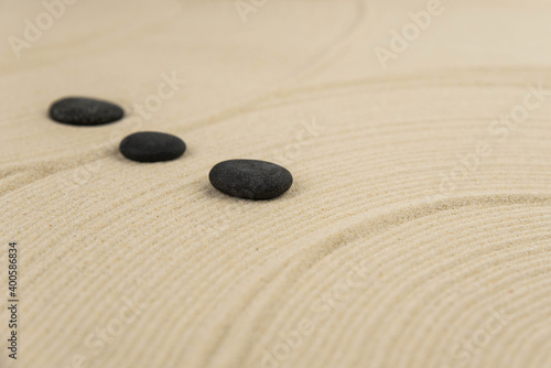 Zen sand garden meditation stone background with copy space. Stones and lines drawing in sand for relaxation. Concept of harmony, balance and meditation, spa, massage, relax. Set Sail Champagne color