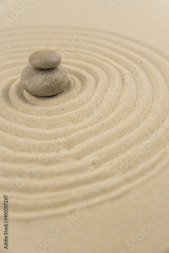 Zen sand garden meditation stone background with copy space. Stones and lines drawing in sand for relaxation. Concept of harmony, balance and meditation, spa, massage, relax. Set Sail Champagne color