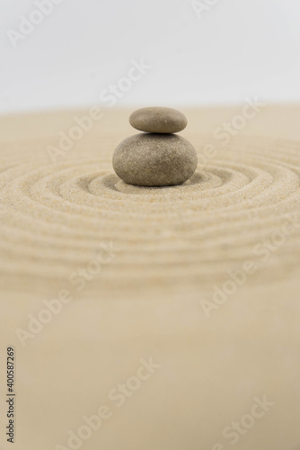 Zen sand garden meditation stone background with copy space. Stones and lines drawing in sand for relaxation. Concept of harmony, balance and meditation, spa, massage, relax. Set Sail Champagne color