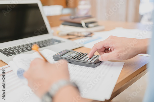 businessman using calculator for calculate budget accountancy, business data. finance and accounting concept