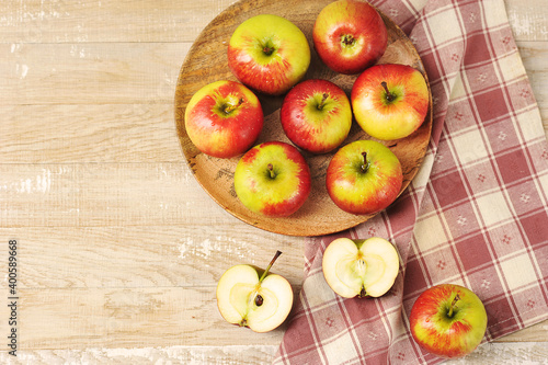 Ripe red apples on wooden plate