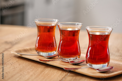 Cups of hot Turkish tea on wooden table