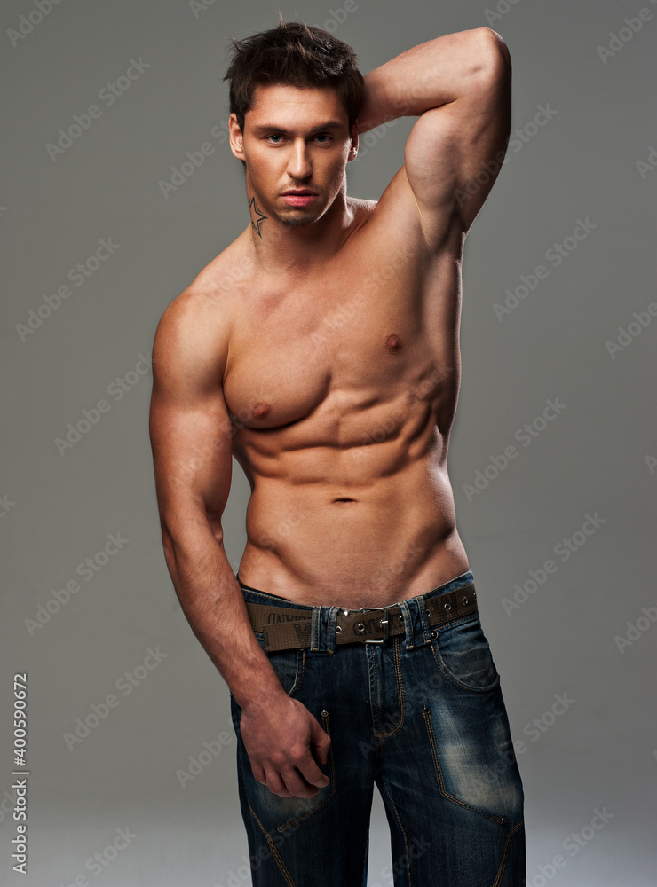 Handsome shirtless man with hands behind his head Handsome shirtless man with hands behind his head