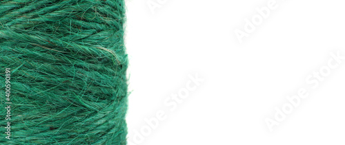 close-up vertical green jute rope reel for DIY and gift wrapping, isolated on white background, sustainable lifestyle