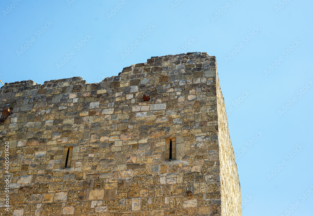 
Gezlevsky gate in Evpatoria. The ancient masonry of the fortress against the blue sky. Shell brick.