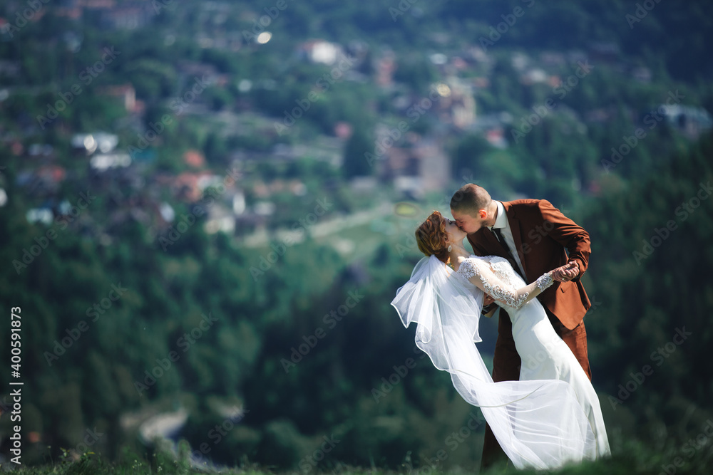 happy stylish bride and groom running and having fun in mountains on summer sunny day. gorgeous newlywed couple laughing, true feelings. emotional romantic moment. happy stylish bride and groom running and having fun in mountains on summer sunny day. gorgeous newlywed couple laughing, true feelings. emotional romantic moment.