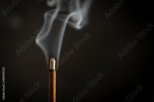Canvas-taulu Asian incense stick burning with smoke, close up, macro