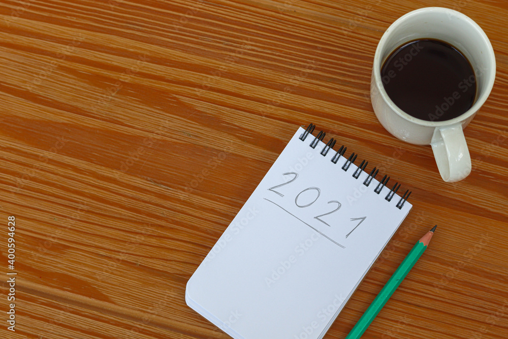 new year's resolutions for 2021 written in notebook on the table new year's resolutions for 2021 written in notebook on the table