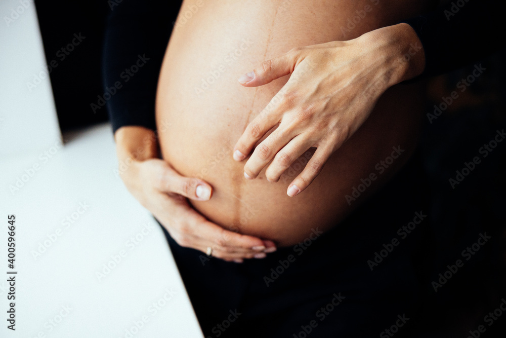 Close up photo shoot of pregnant bump with hands on it. Close up photo shoot of pregnant bump with hands on it.