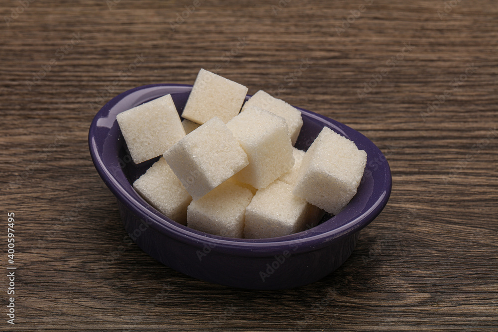 Refined white sugar cubs in the bowl Refined white sugar cubs in the bowl