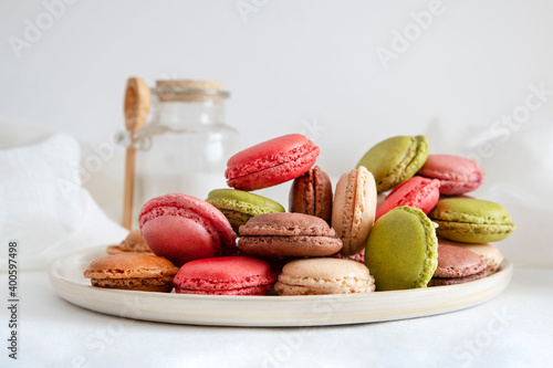 Assortments of coloured macaroons stacked on a plate