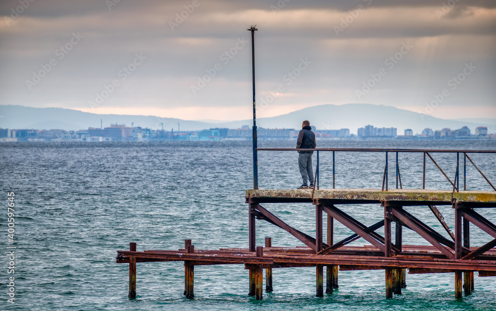 men watching the sea from the pier