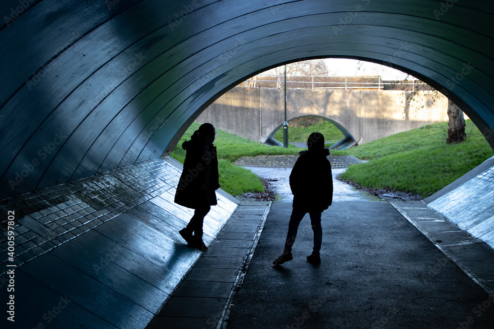 Two children talking in a underpass