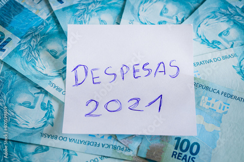 budget 2021. Handwritten inscription on a piece of paper in Brazilian. Money from Brazil. Home finances and money concept for the new year